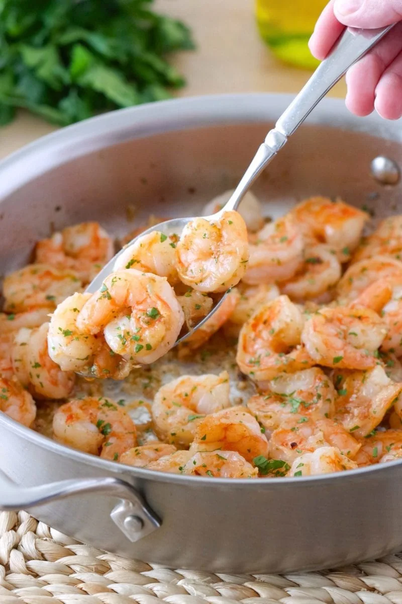 Shrimp Scampi, sauteed in a skillet, in a garlic, white wine and fresh herbs