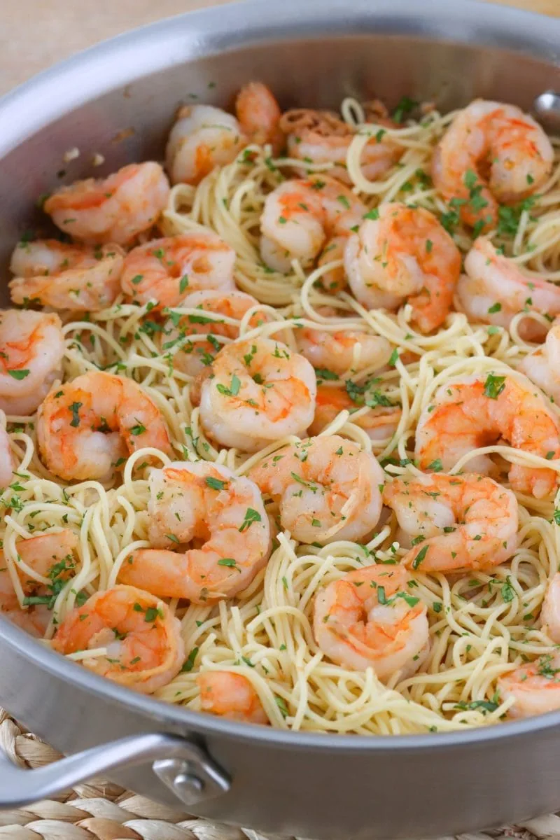 Shrimp Scampi Pasta, juicy sauteed shrimp in a rice garlicky sauce and served with angel hair pasta.