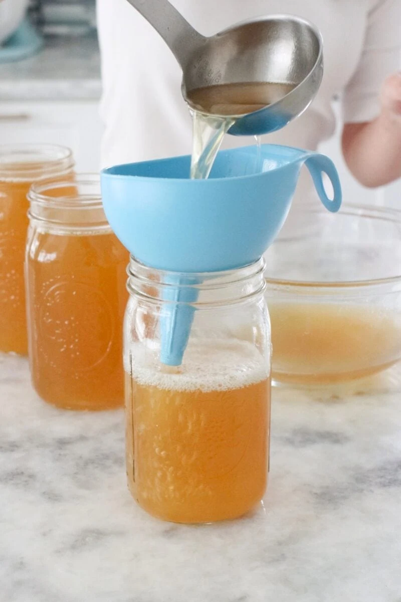 Instant Pot Chicken Broth, strained and poured into jars