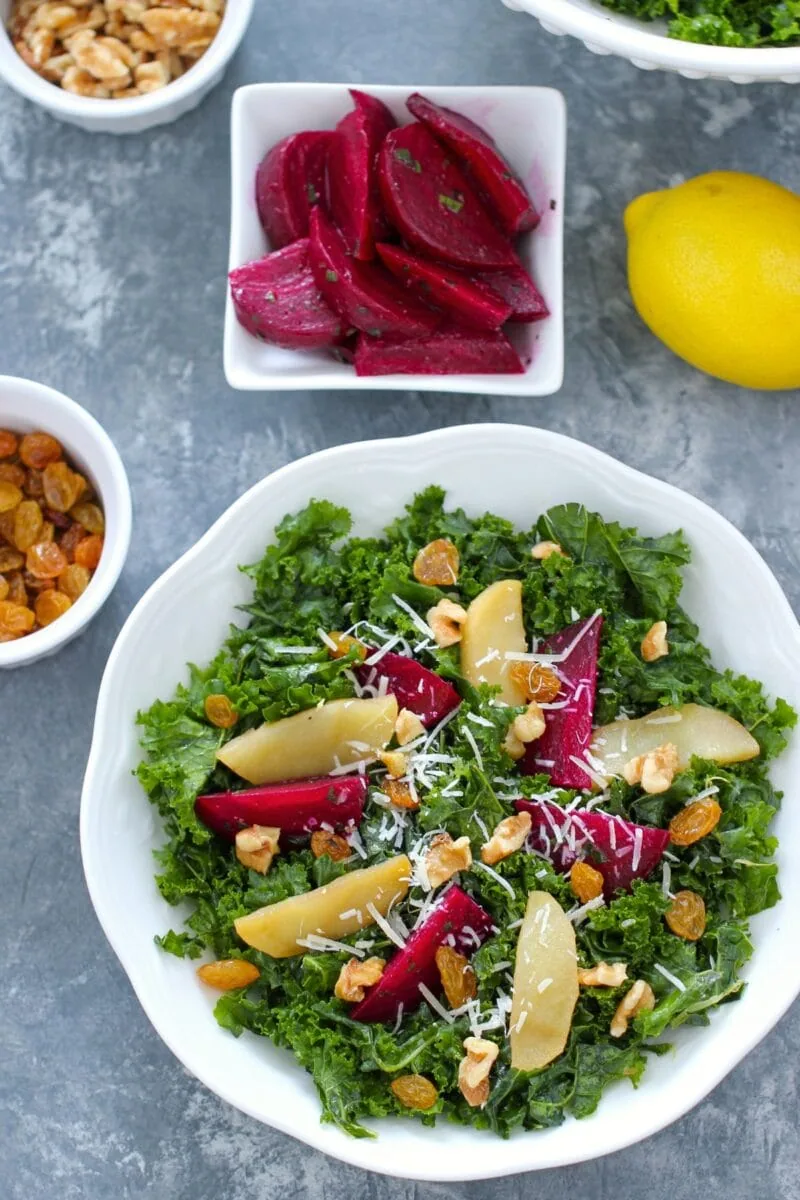 Kale Beet Salad on a plate (with apples, raisins, and walnuts)