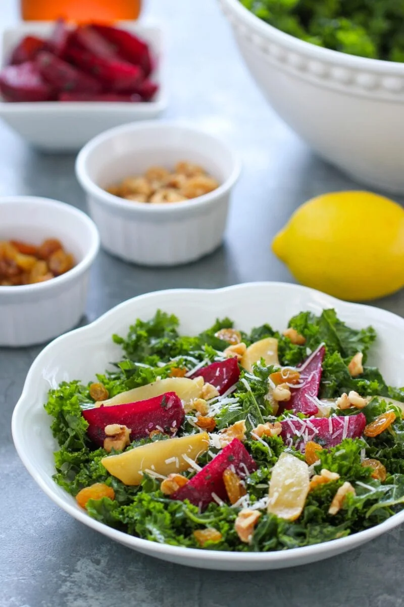 Kale Beet Salad made with roasted beets, honeyd apples, walnuts, golden raisins and cider vinaigrette