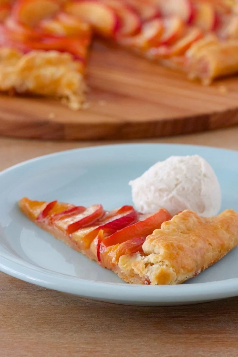 A slice of Nectarine Galette with a scoop of vanilla ice cream 