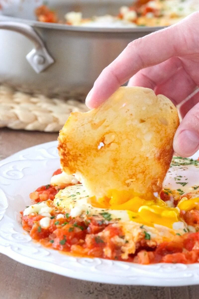 Shakshuka with fresh tomatoes served with toast