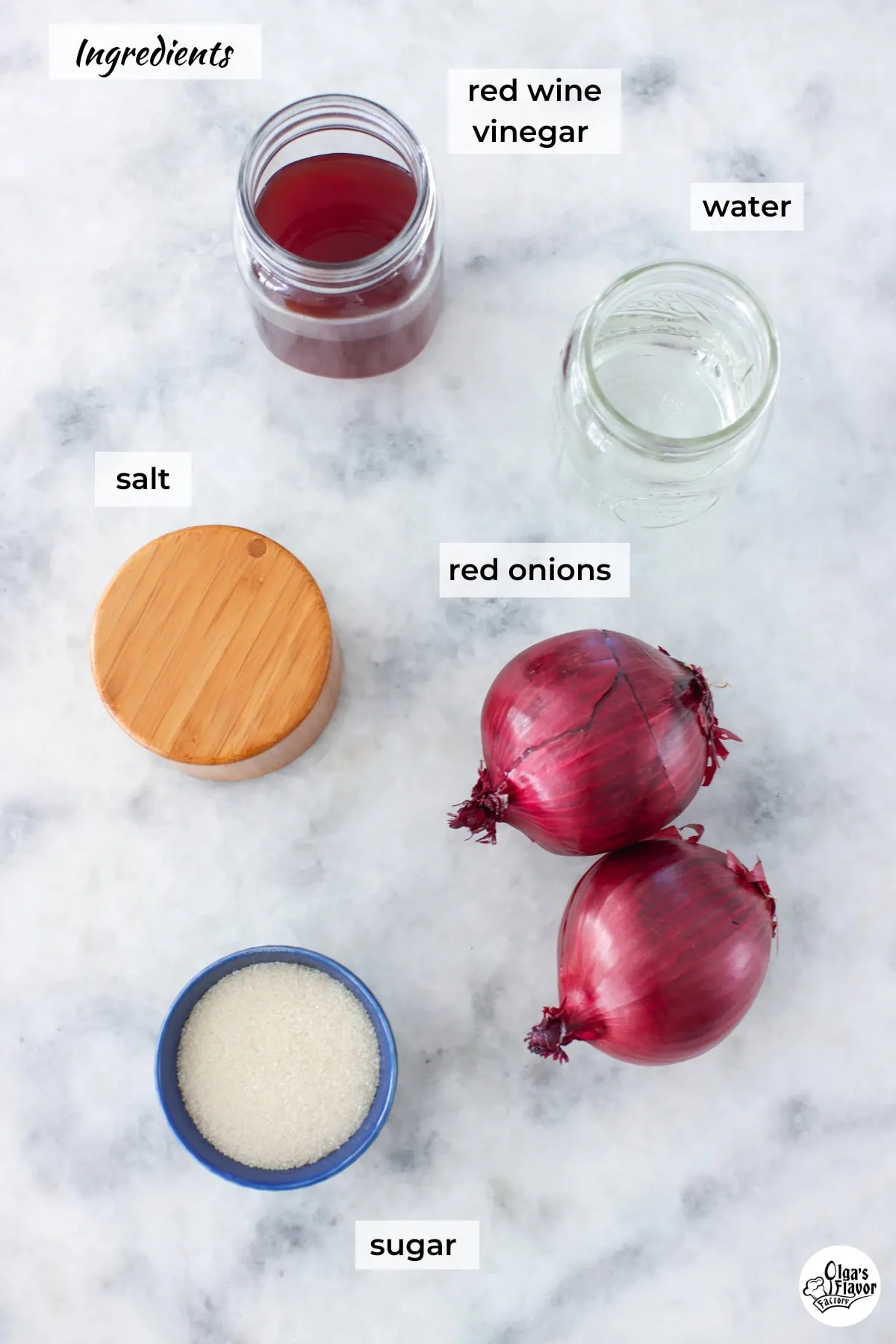 Ingredients for easy pickled red onions on a marble counter. 